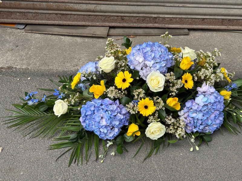 Blue, white & yellow casket spray