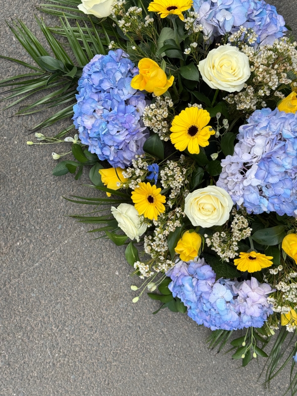 Blue, white & yellow casket spray