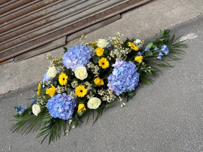 Blue, white & yellow casket spray