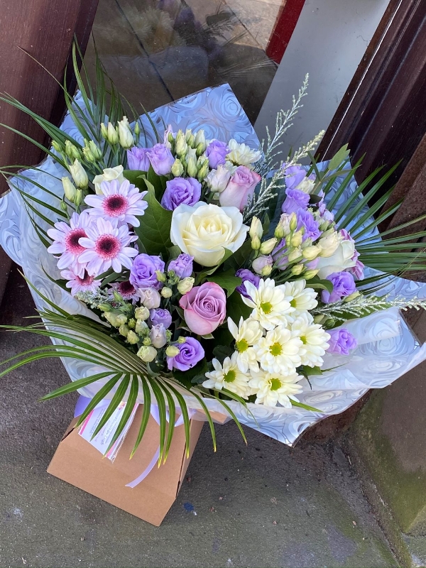 Lilac and cream dream bouquet. Lilac lisianthus, cream roses and chrysanthemums. Boxed bouquet in water