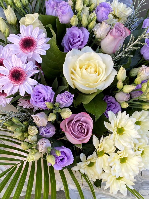Lilac and cream dream bouquet. Lilac lisianthus, cream roses and chrysanthemums. Boxed bouquet in water