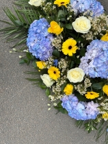 Blue, white & yellow casket spray