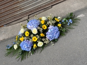 Blue, white & yellow casket spray
